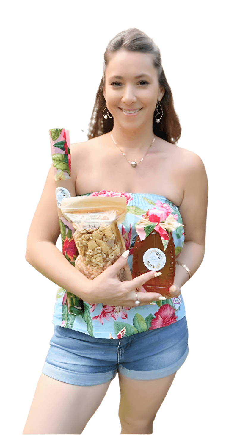 Kristal from Tynanes Bee Farms holding a bag of honey snack mix and a bottle of honey